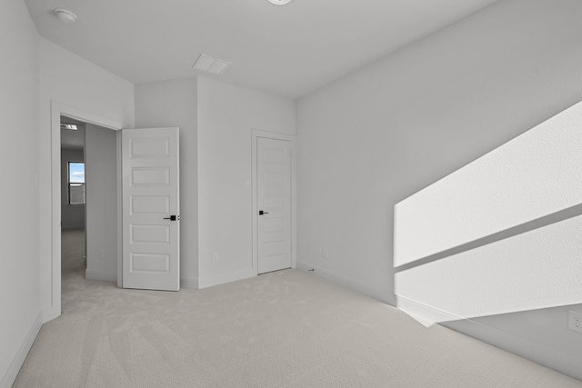 unfurnished bedroom featuring light carpet