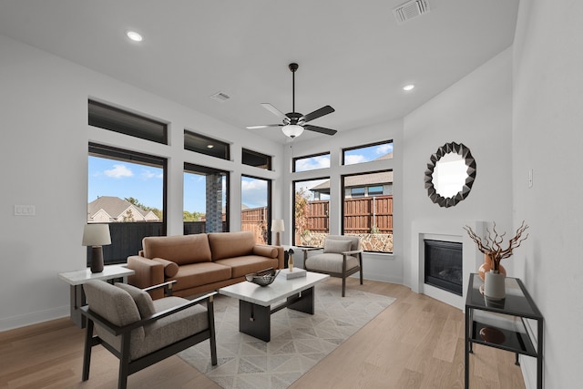 living room with ceiling fan and light hardwood / wood-style floors