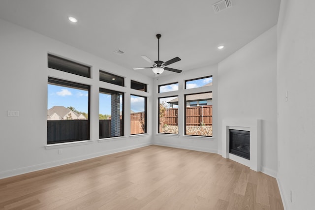 unfurnished living room with light hardwood / wood-style flooring and ceiling fan