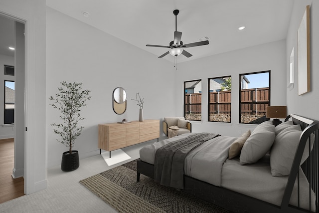 bedroom featuring multiple windows, ceiling fan, and wood-type flooring