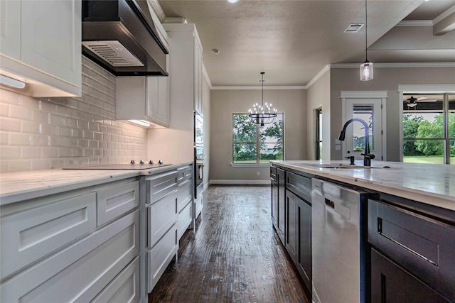 kitchen with tasteful backsplash, dishwasher, white cabinets, and wall chimney range hood