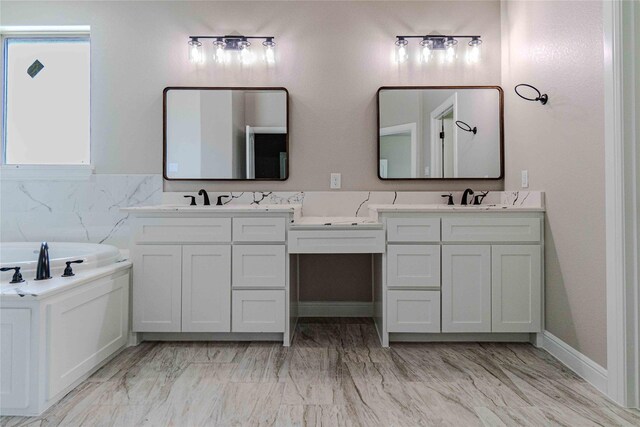 bathroom with vanity and a bath