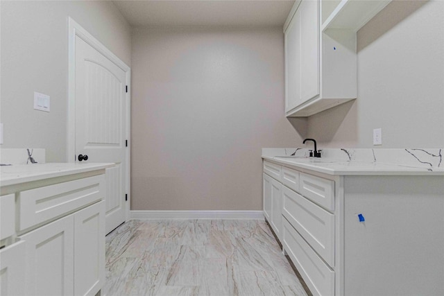 clothes washing area with sink