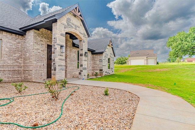 view of side of property with a yard and a garage