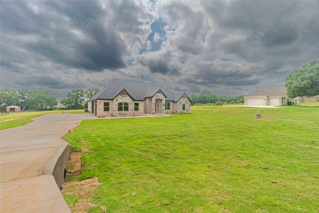 view of front of property with a front yard and a garage