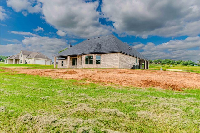 rear view of house with a yard