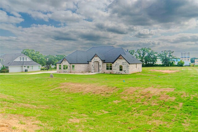 french country style house with a front yard