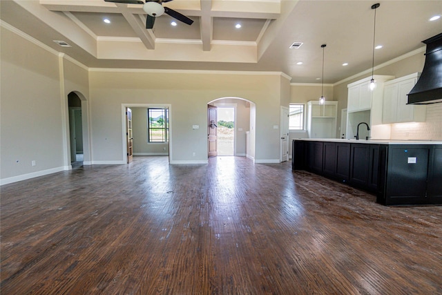 kitchen featuring coffered ceiling, ceiling fan, pendant lighting, beamed ceiling, and white cabinetry