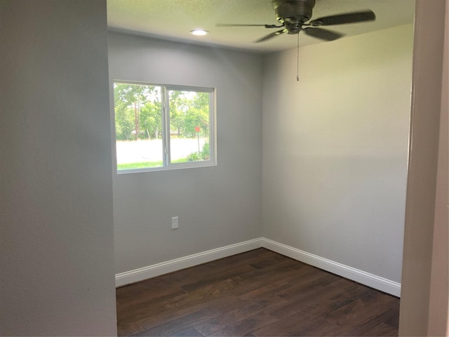 unfurnished room with dark hardwood / wood-style floors and ceiling fan