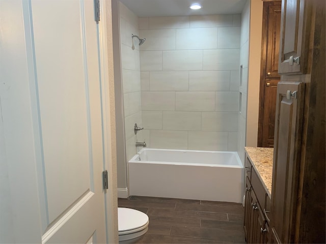 full bathroom featuring vanity, toilet, and tiled shower / bath