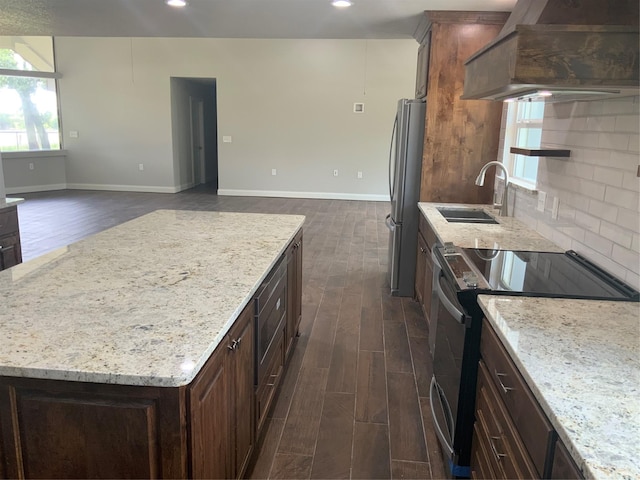 kitchen featuring backsplash, sink, stainless steel appliances, and dark hardwood / wood-style floors