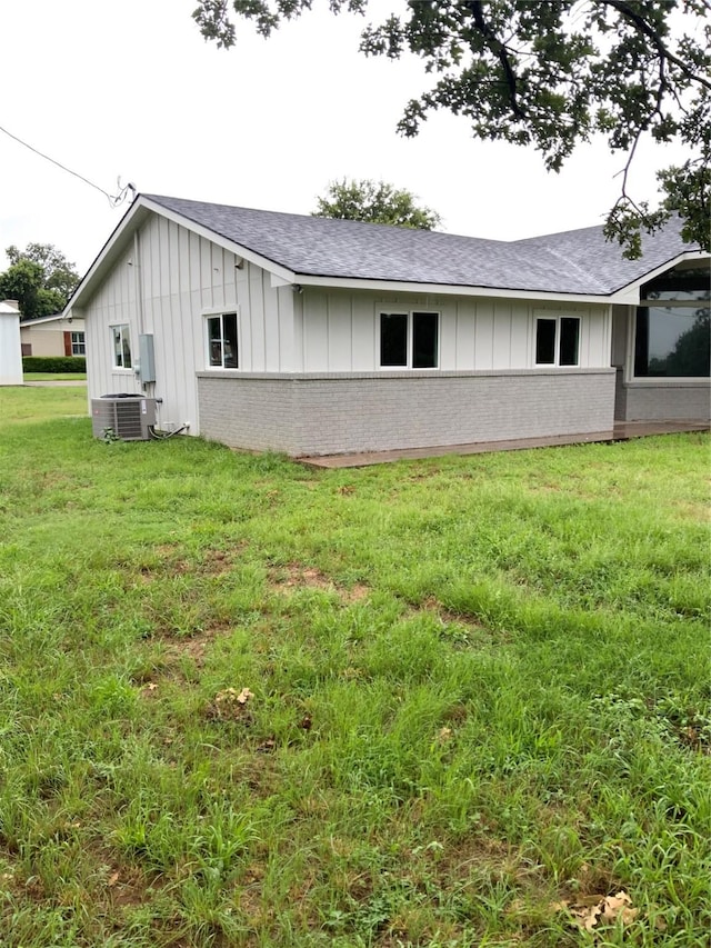 view of home's exterior with a yard and cooling unit