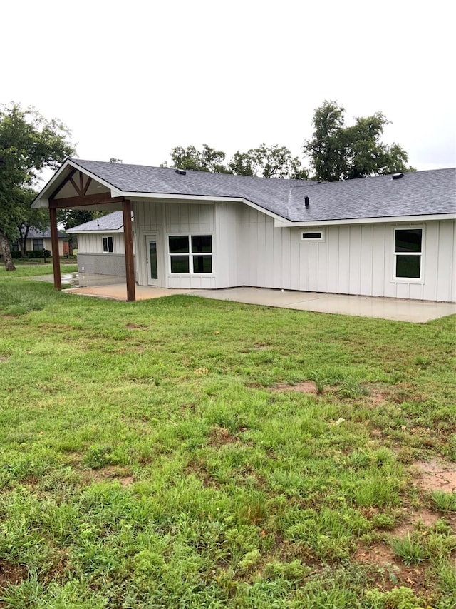 rear view of house featuring a patio area and a yard