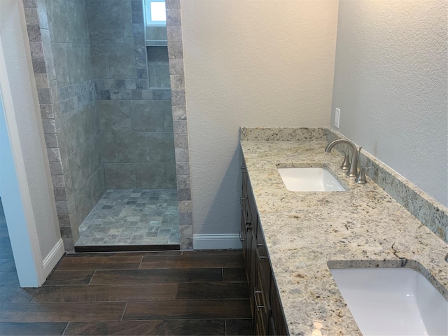 bathroom featuring vanity and a tile shower