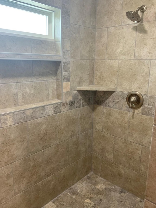 interior details with a tile shower