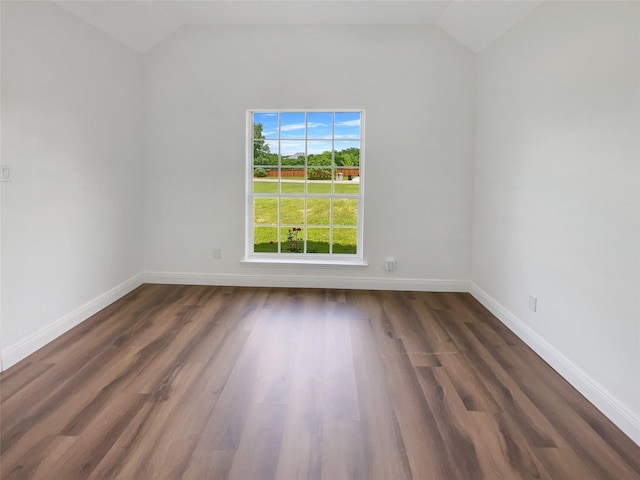 unfurnished room featuring dark hardwood / wood-style floors and lofted ceiling