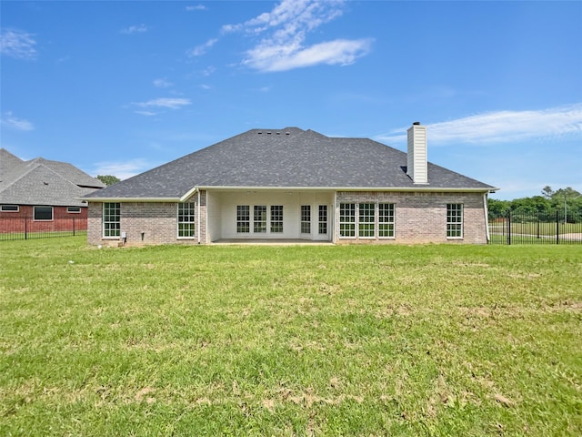 back of house featuring a yard