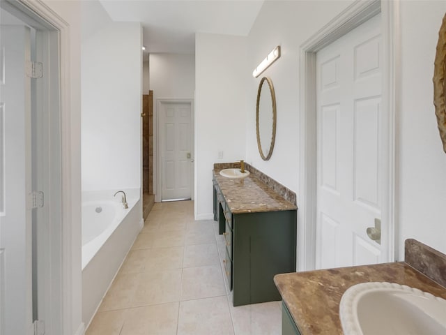 bathroom with tile patterned flooring, vanity, and a washtub