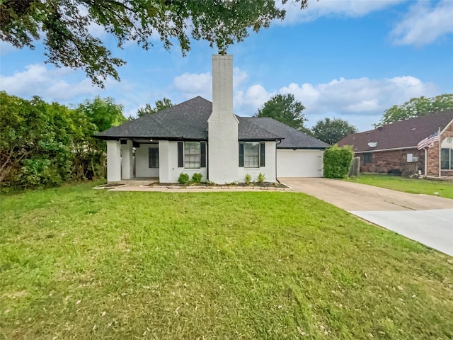 view of front of home with a garage and a front yard