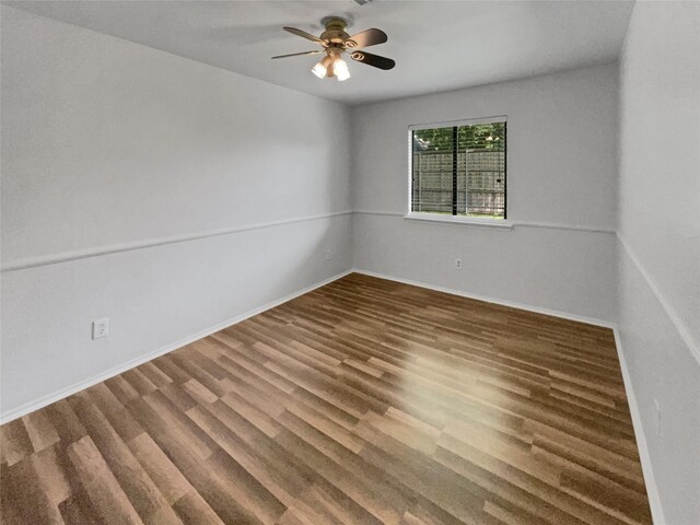 unfurnished room featuring ceiling fan and dark hardwood / wood-style flooring