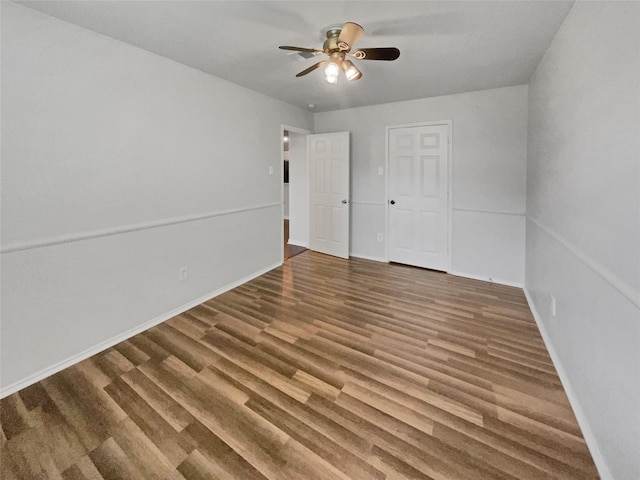 interior space featuring ceiling fan and dark hardwood / wood-style flooring