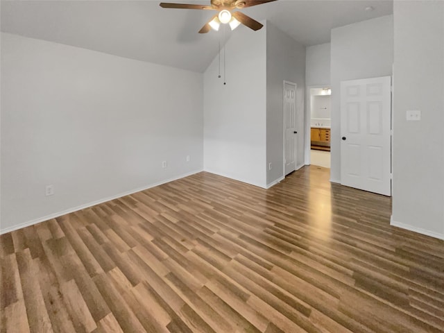 empty room featuring ceiling fan, high vaulted ceiling, and hardwood / wood-style floors