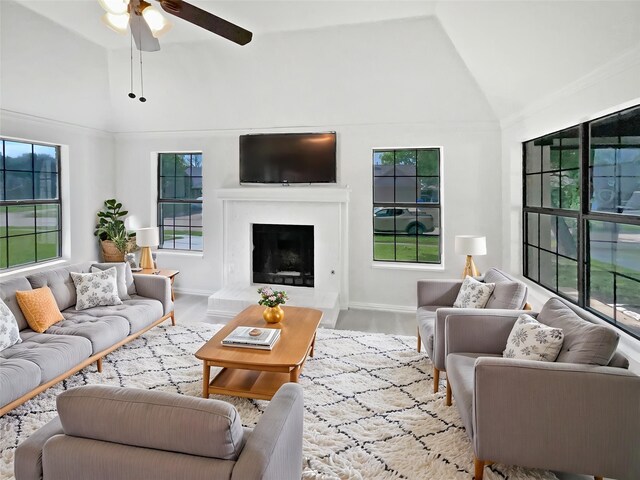 kitchen with a sink, appliances with stainless steel finishes, lofted ceiling, a ceiling fan, and white cabinets