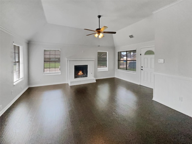 unfurnished living room with crown molding, vaulted ceiling, ceiling fan, a fireplace, and dark hardwood / wood-style floors