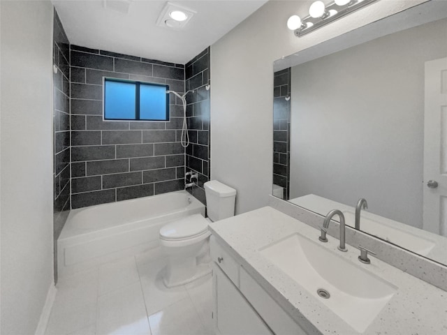 full bathroom with tile patterned floors, toilet, tiled shower / bath, and vanity