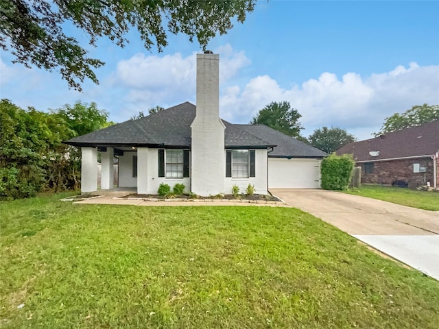 view of front of property with a front yard and a garage