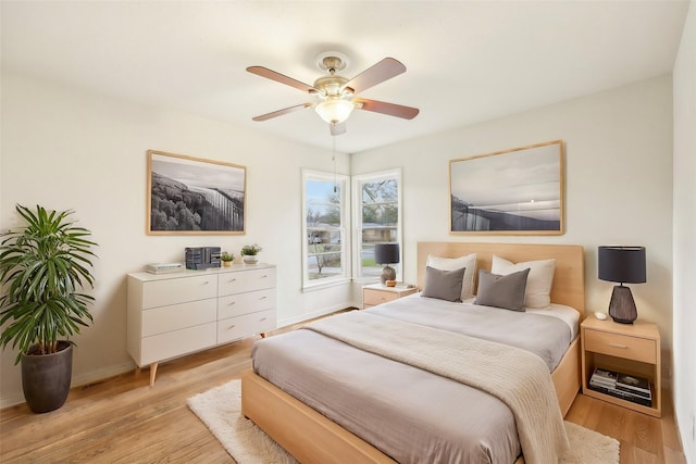 bedroom with ceiling fan and light hardwood / wood-style floors