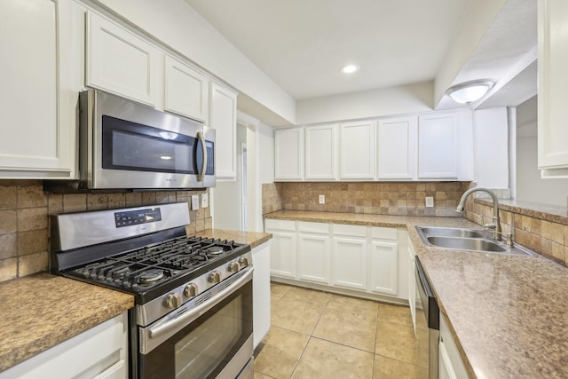 kitchen featuring sink, stainless steel appliances, and white cabinetry