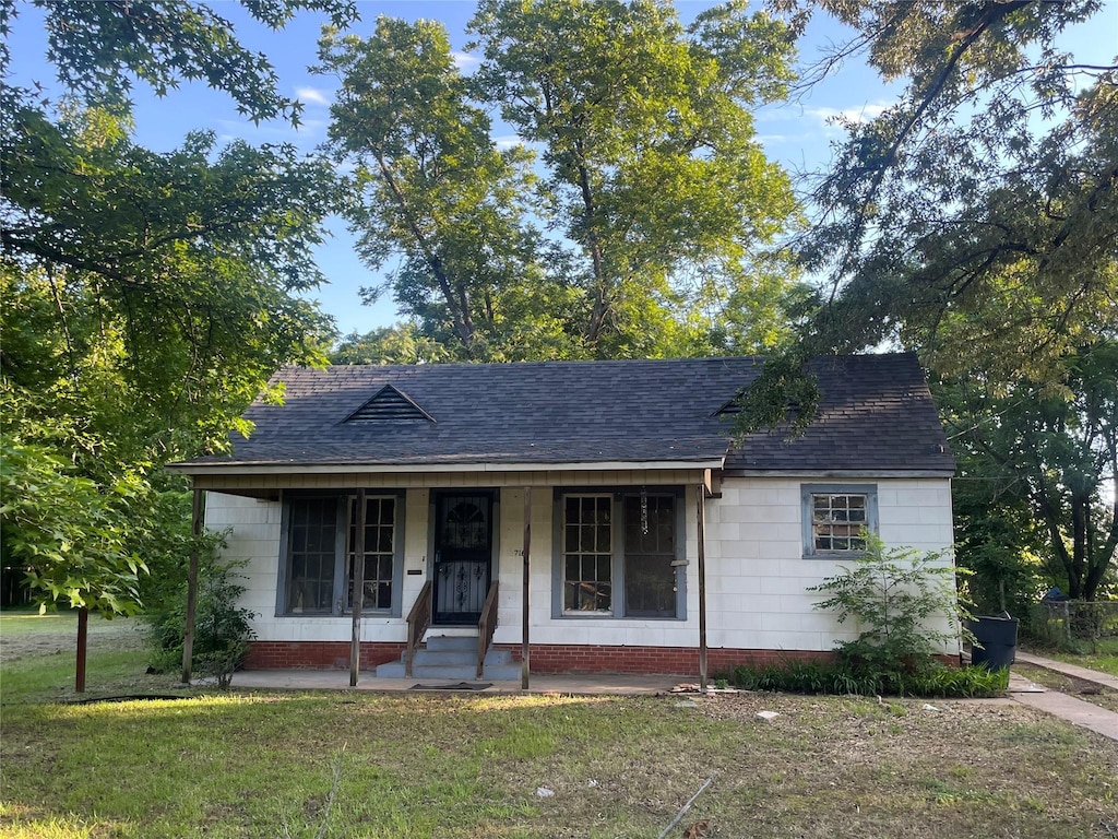 view of front of home with a front yard and a porch