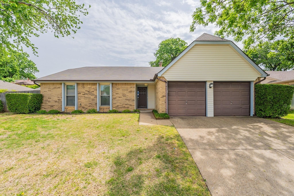 ranch-style house with a front lawn and a garage