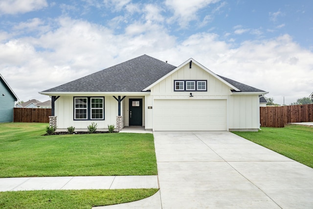 view of front of property with a front yard and a garage