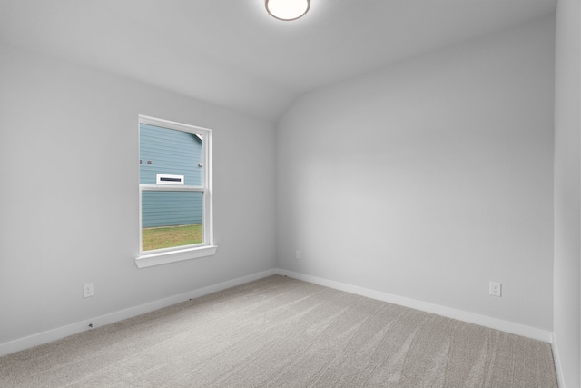 unfurnished room with lofted ceiling and carpet floors