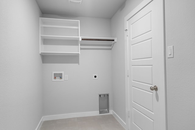 laundry area with hookup for a washing machine, light tile patterned floors, and electric dryer hookup