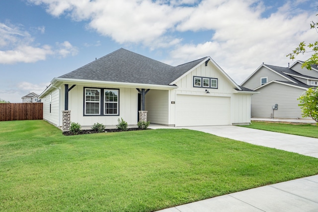 view of front of house with a garage and a front lawn