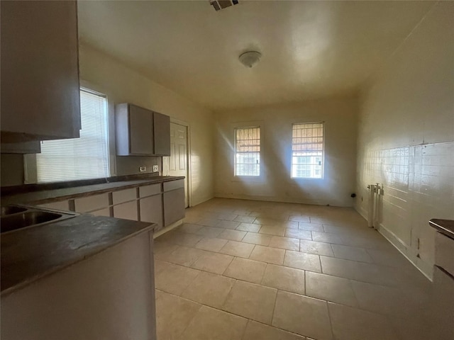 kitchen with light tile patterned flooring and sink