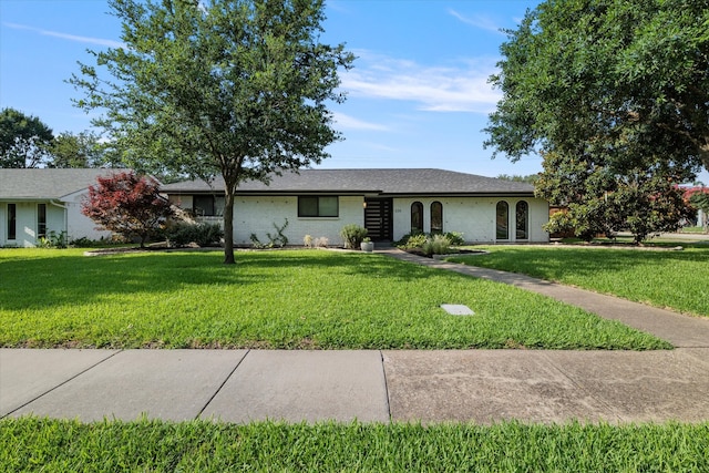 ranch-style home featuring a front yard