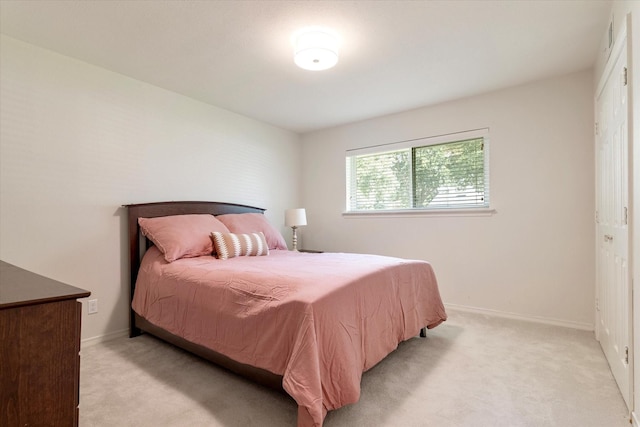 bedroom featuring light carpet