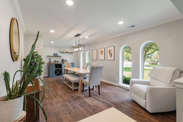 dining room with dark wood-type flooring, a notable chandelier, and ornamental molding