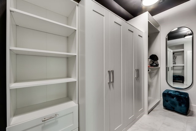 spacious closet with light tile floors