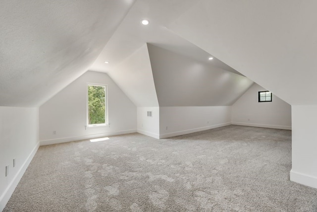 bonus room featuring carpet flooring and vaulted ceiling