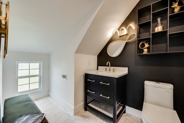 bathroom with vaulted ceiling, vanity, toilet, and tile floors