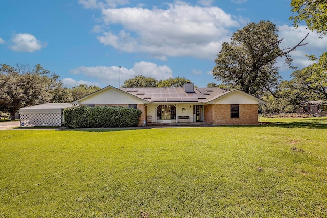 ranch-style house with solar panels and a front yard