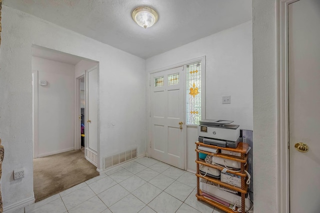 foyer featuring light carpet