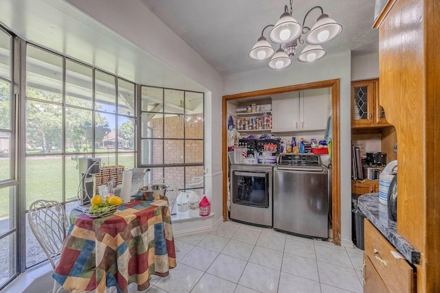 kitchen featuring an inviting chandelier, washer and clothes dryer, and light tile patterned flooring