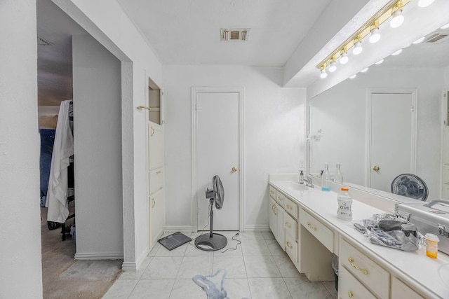 bathroom with tile patterned flooring and vanity