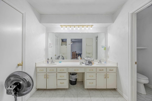 bathroom featuring vanity, toilet, and ceiling fan